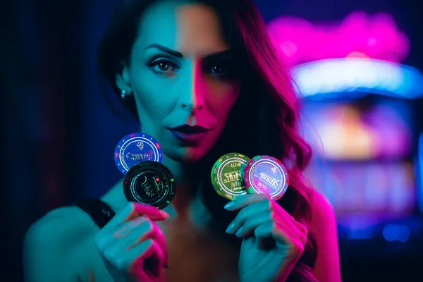 ZS777 Slots — Thousands of thrilling machines await A woman smiling by bright slot machines showing lucky symbols, showcasing the exciting slot offerings at ZS777.